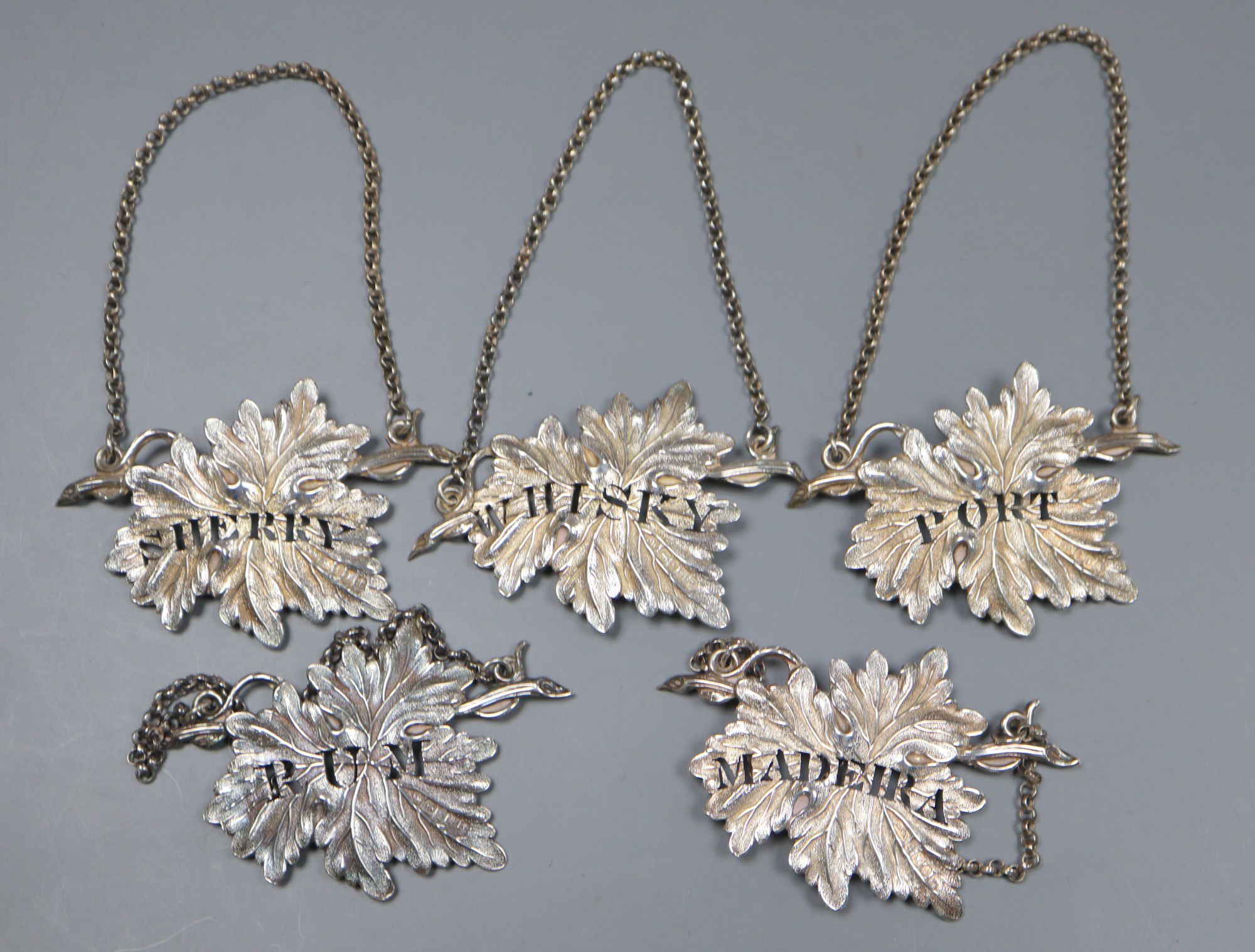 A set of three Victorian silver leaf wine labels, Yapp & Woodward, Birmingham, 1846, 7cm and one other pair.